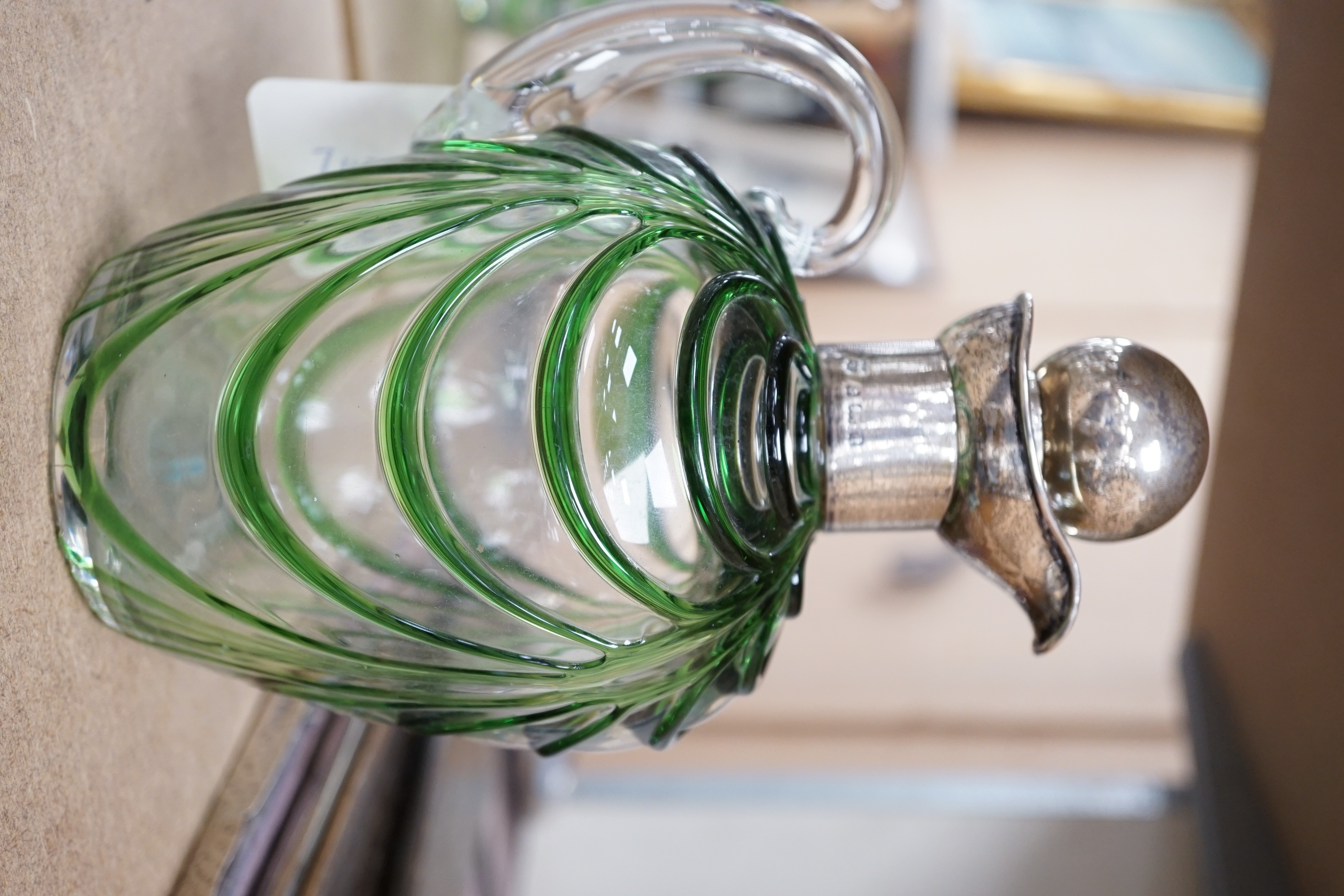 A late Victorian Art Nouveau silver mounted glass claret jug and stopper, D & M Davis, Birmingham, 1900, the glass with ribbed green swags, height 20.7cm.